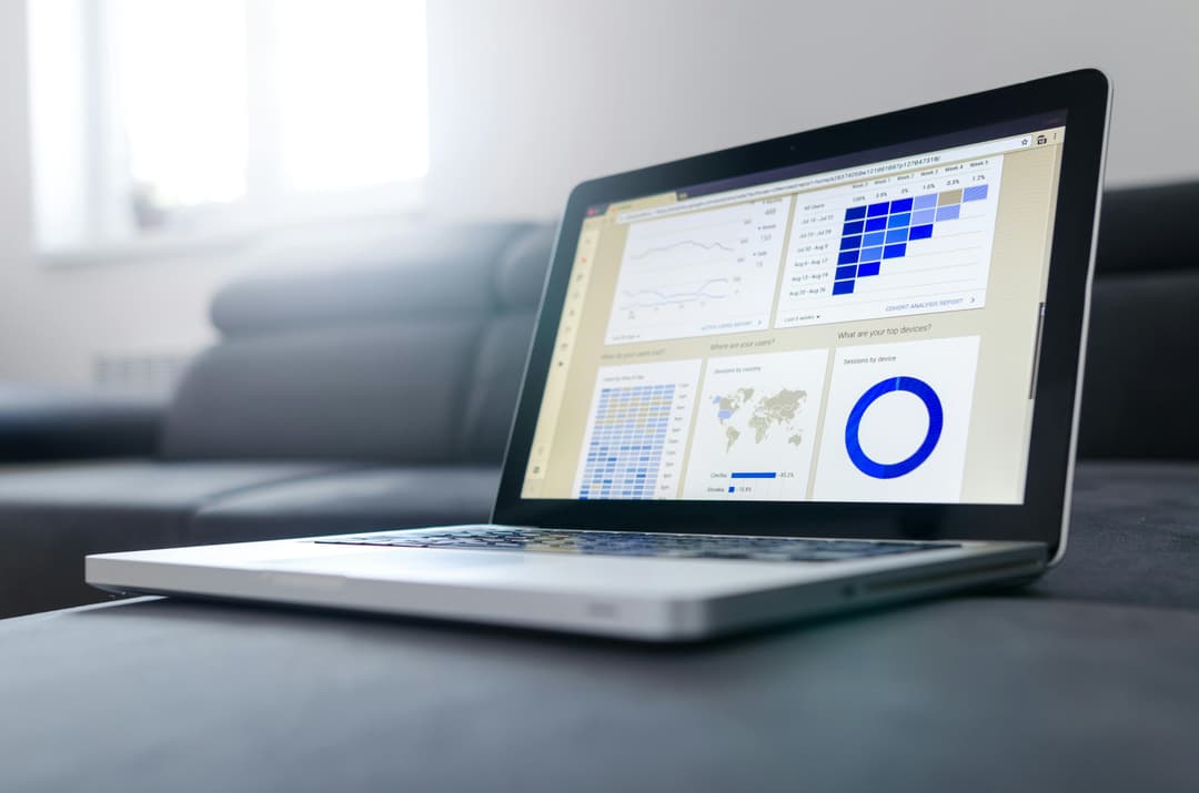 Laptop displaying data charts and graphs